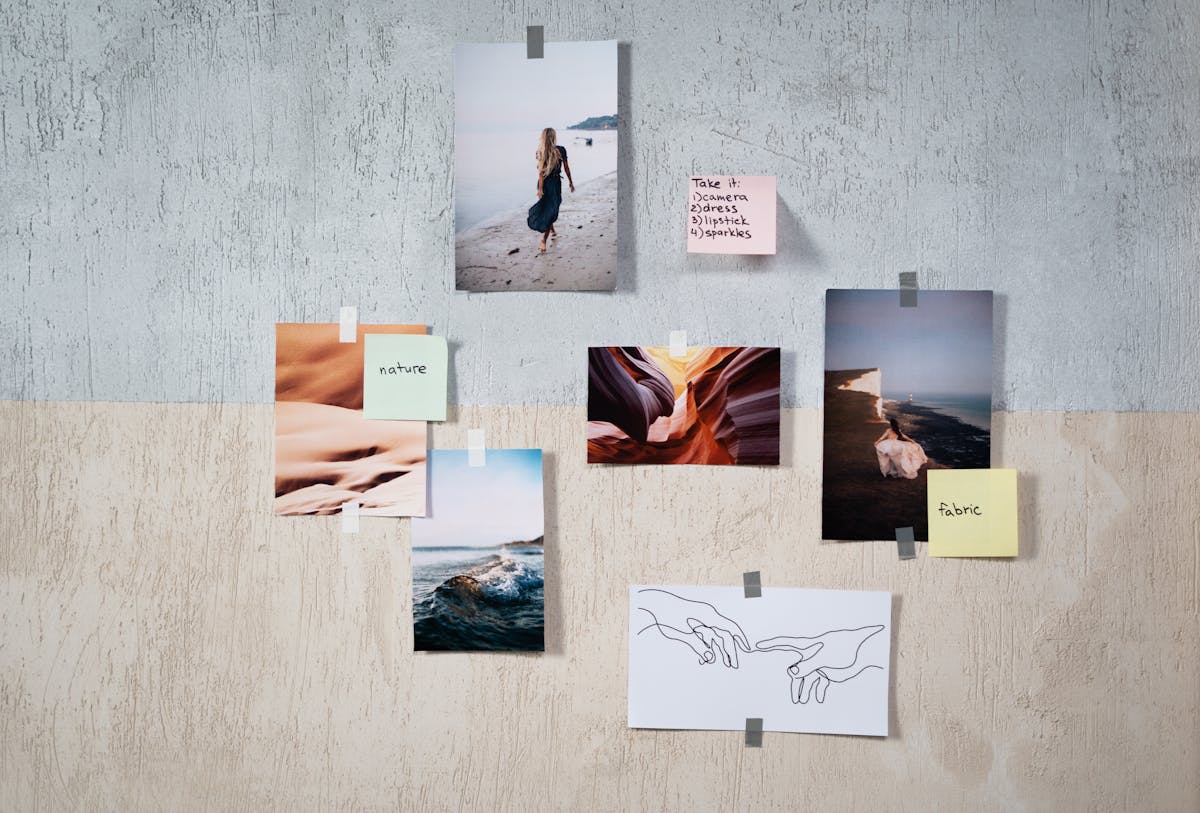 A creative collage of photographs and drawings taped to a textured wall