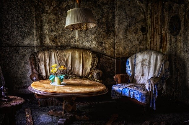 A hotel room with a bed, chair and table